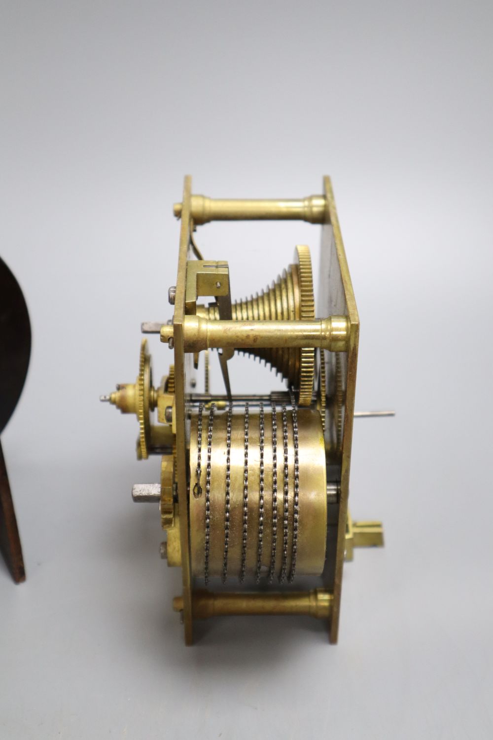 A brass GWR timepiece, a Smiths oak framed timepiece and a fusee clock movement